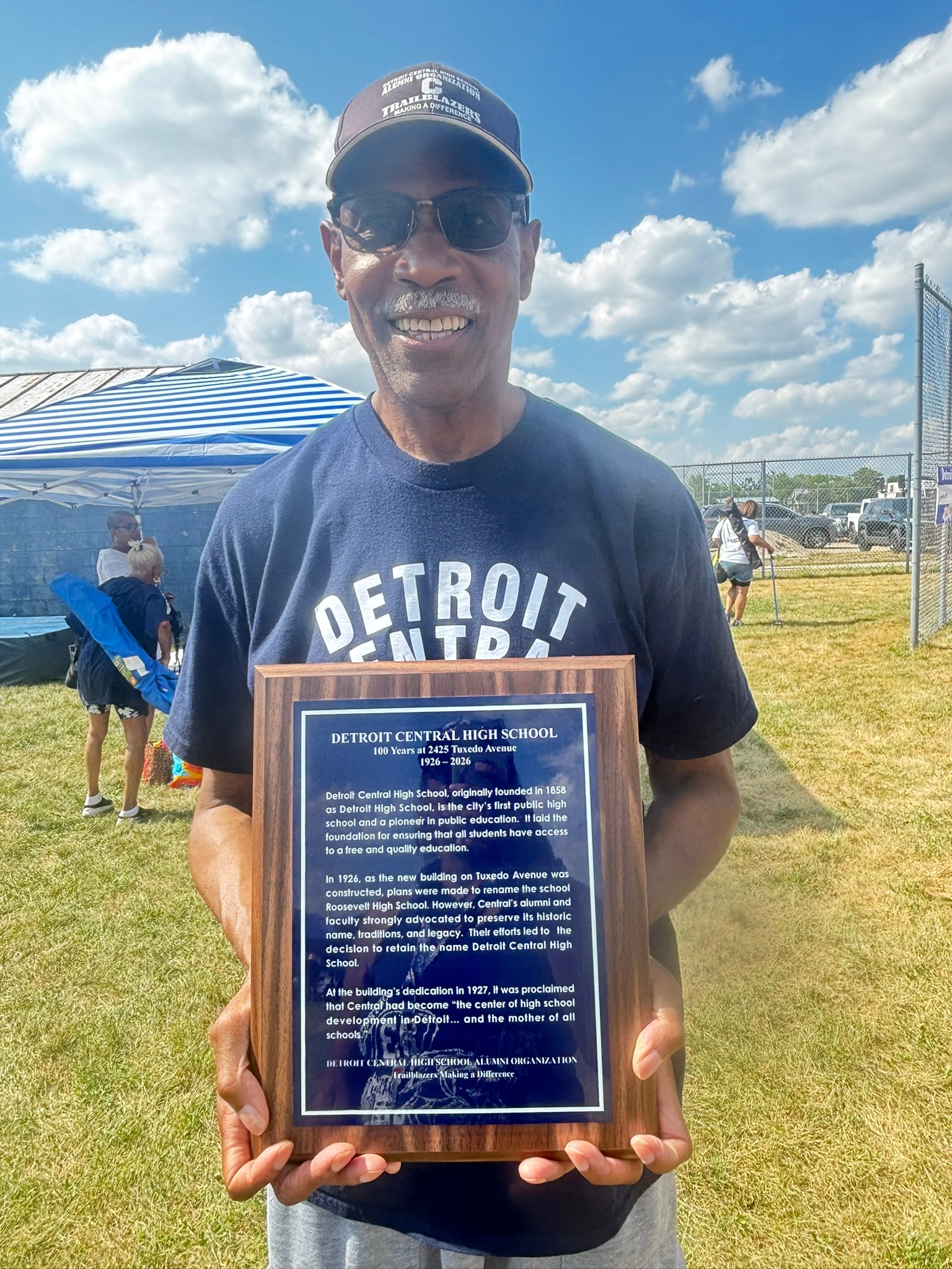 Man holding Detroit Central High School plaque