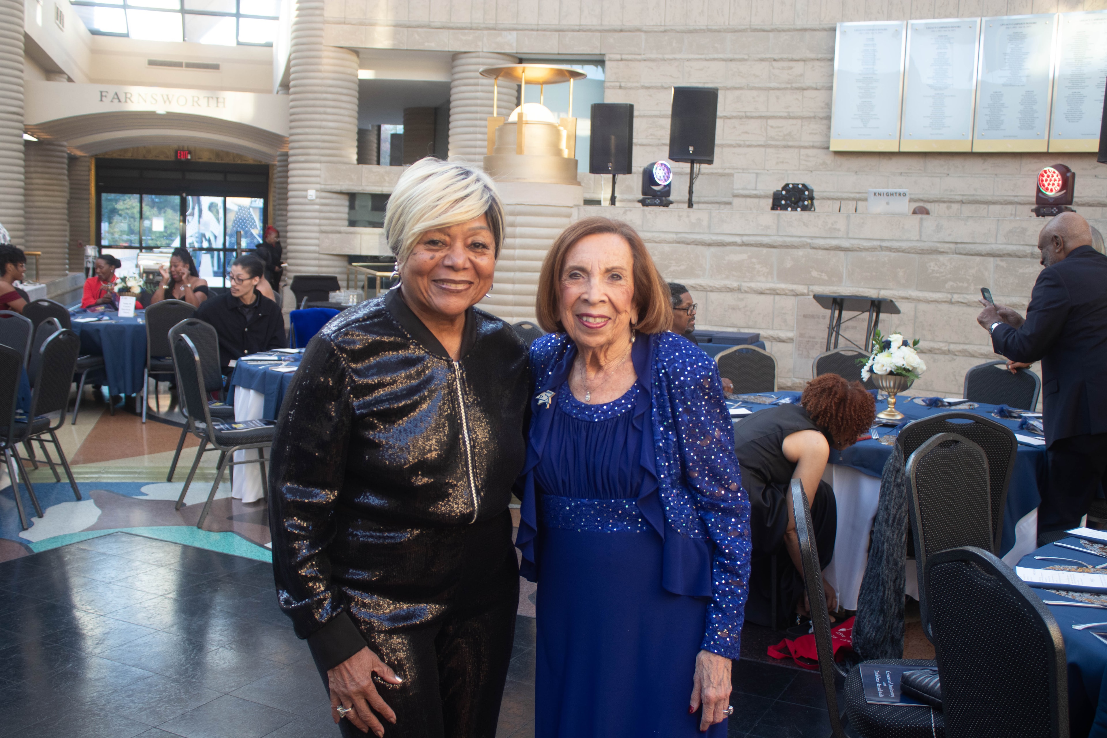 Two women posing at formal event venue