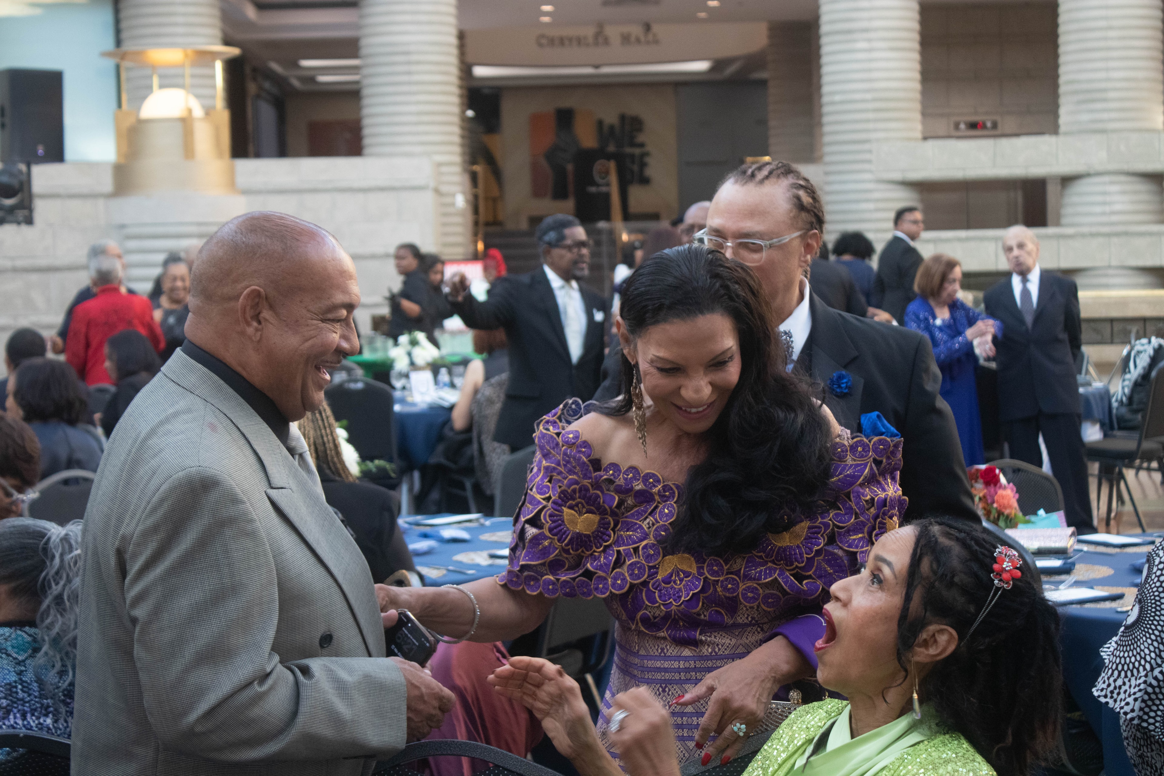 Formal event guests mingling indoors