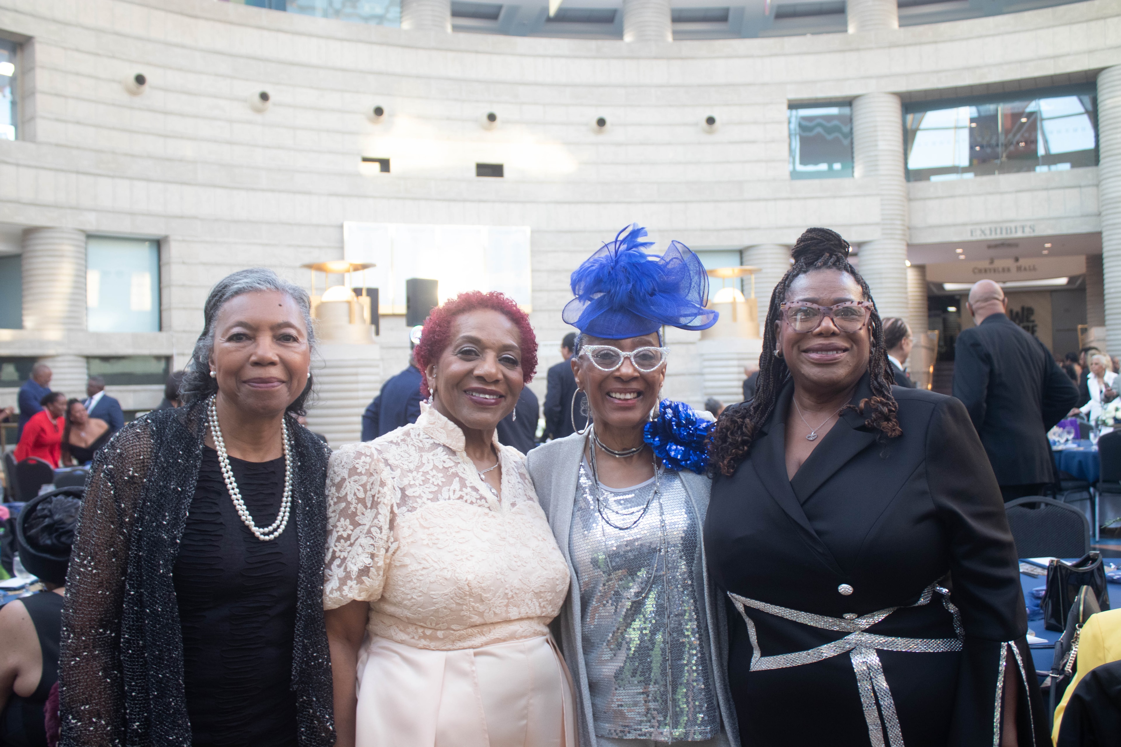Four women dressed up at formal event