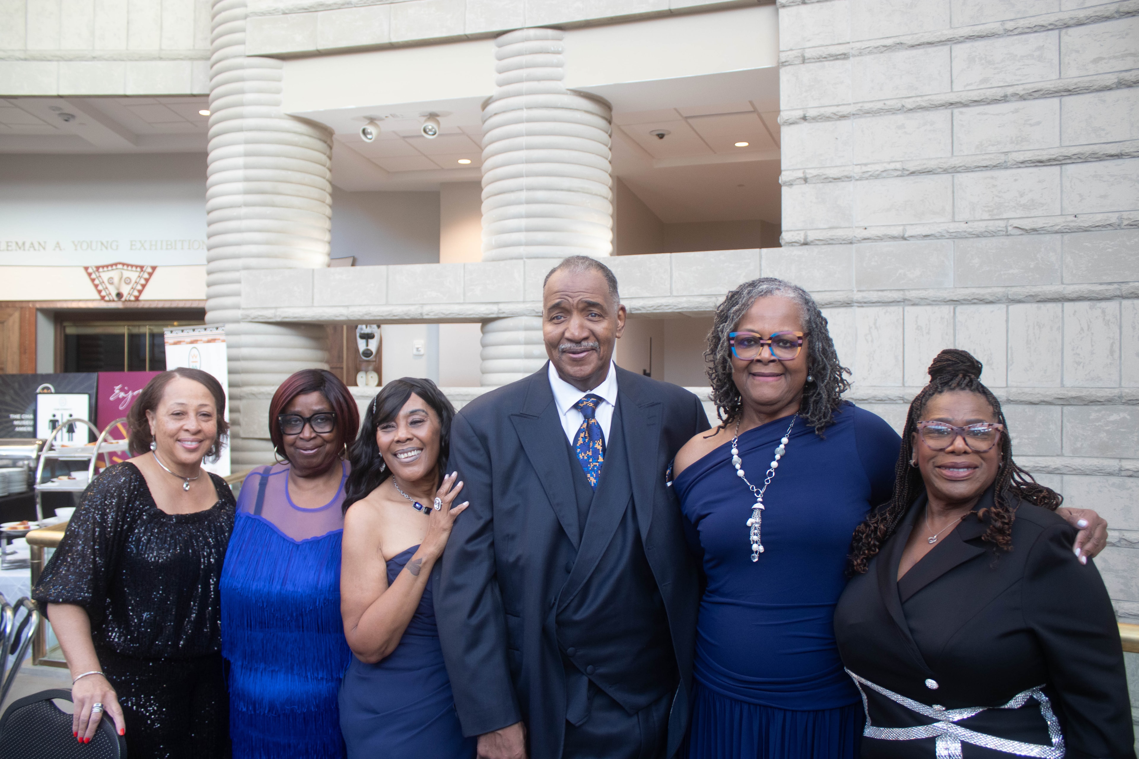 Group of six people posing formal event