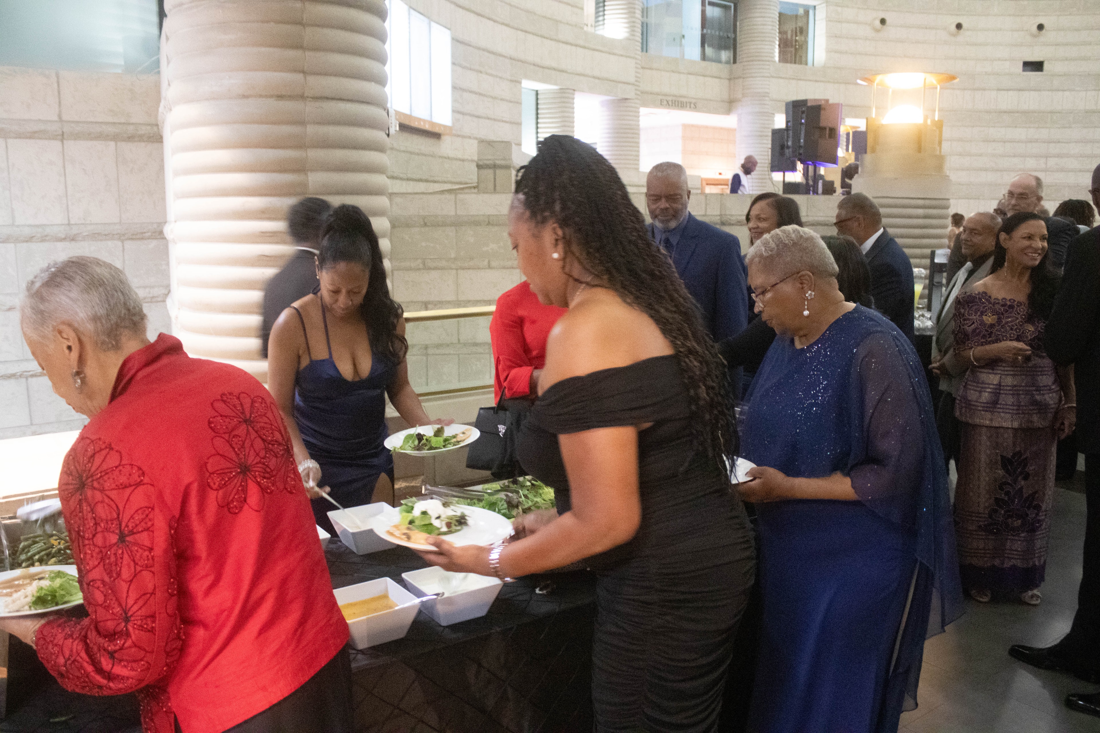 People serving food at formal event