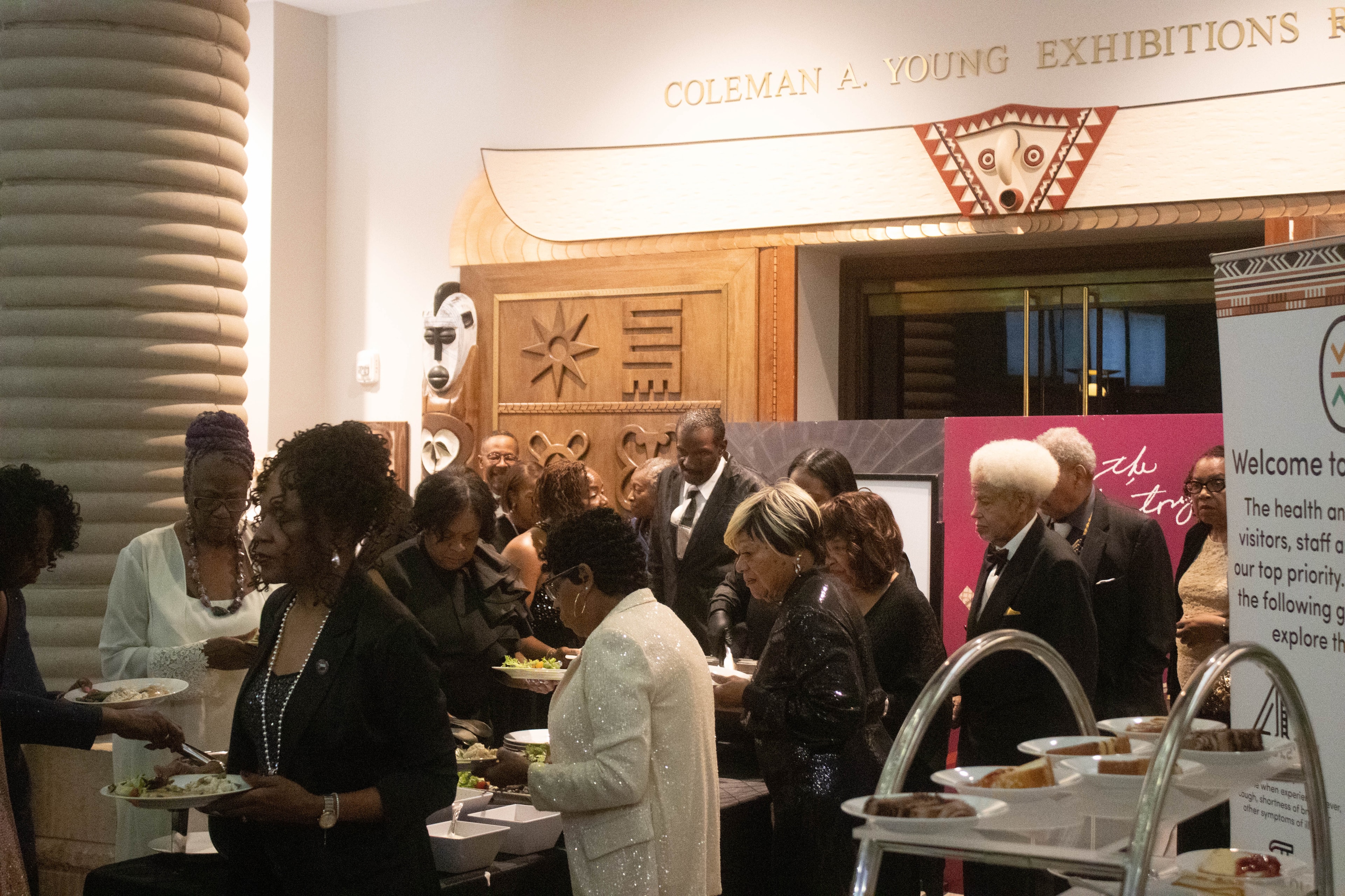 Formal museum reception with guests mingling