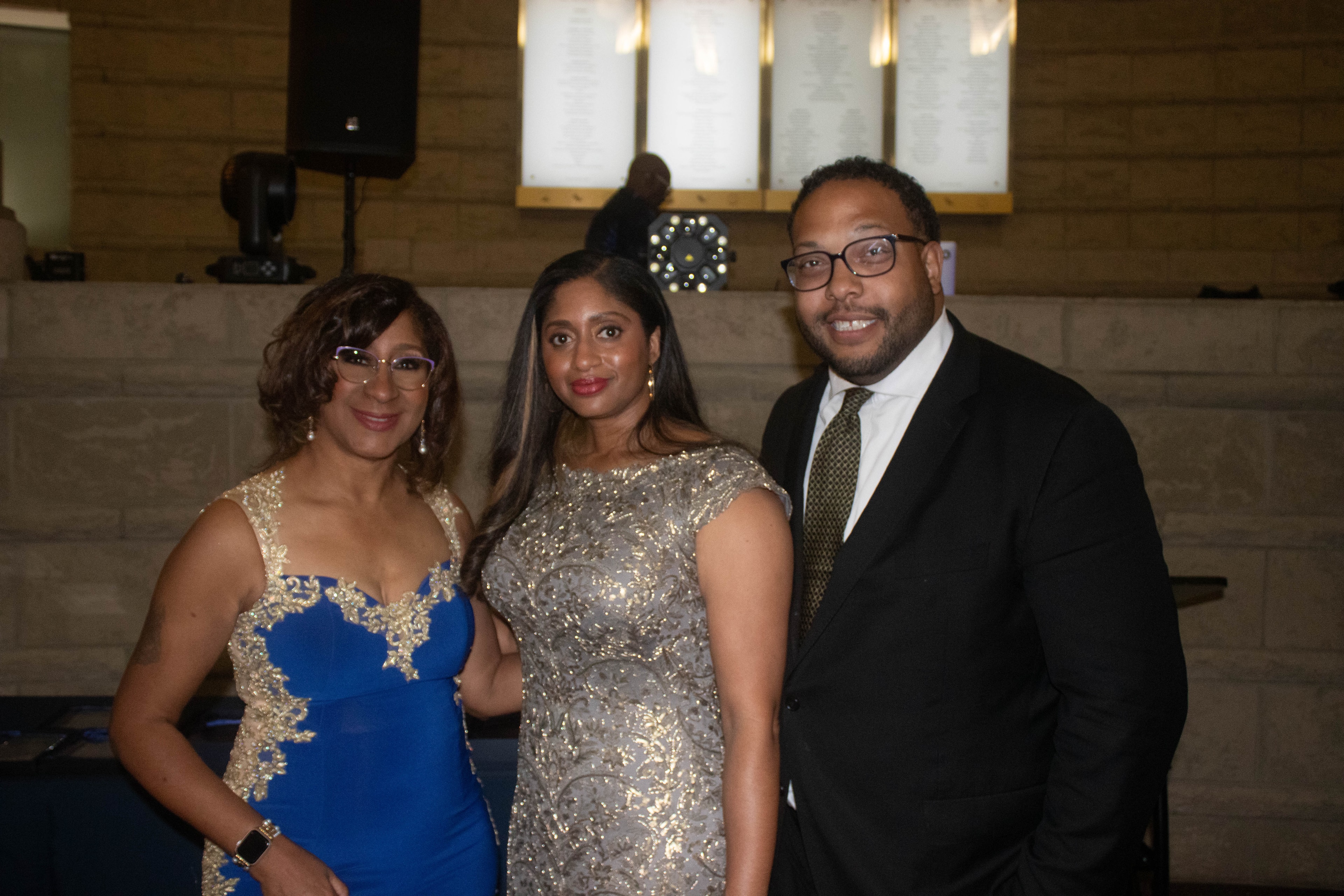 Three people dressed formal event portrait